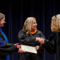 Faculty receiving award and shaking hands with Provost